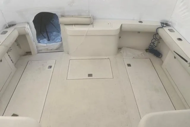 Slide: The Image of 2003 Cabo 35 Express boat interior with spacious deck and storage compartments. - 36