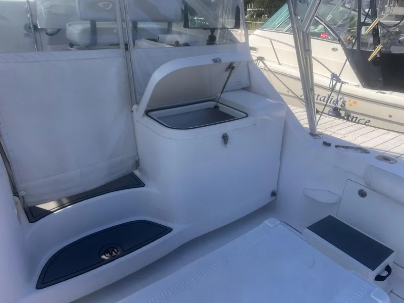 Slide: The Image of 2003 Cabo Express boat interior with seating and storage area. - 9