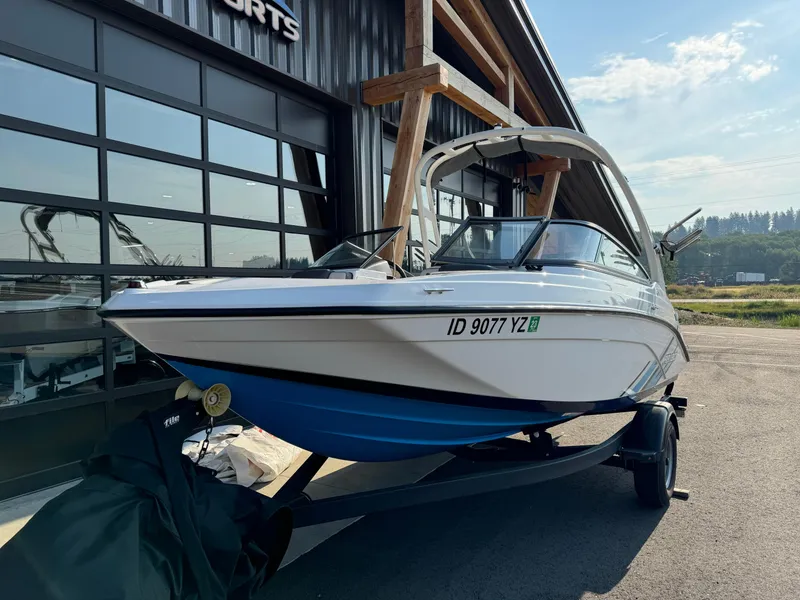 Slide: The Image of 2021 Yamaha AR190 boat on trailer outside a modern building. - 3