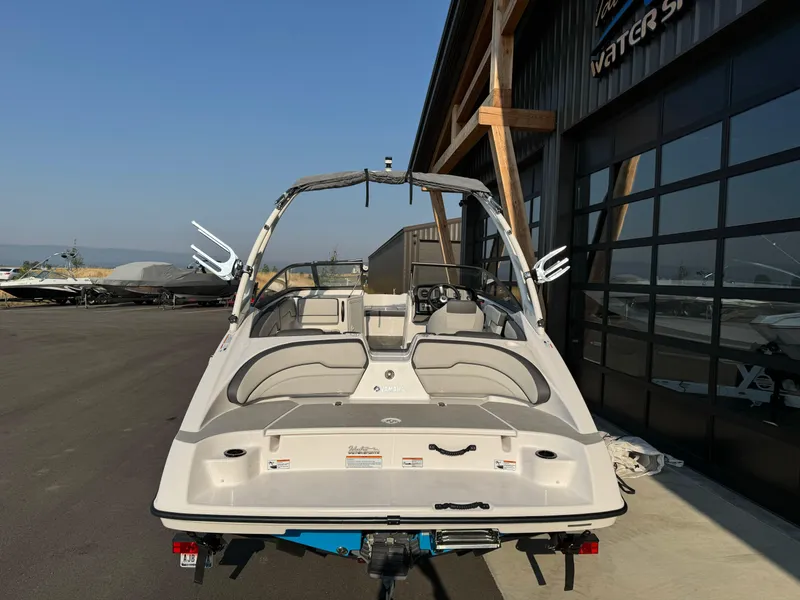 Slide: The Image of 2021 Yamaha Boats AR190 parked outside a watersports facility. - 5
