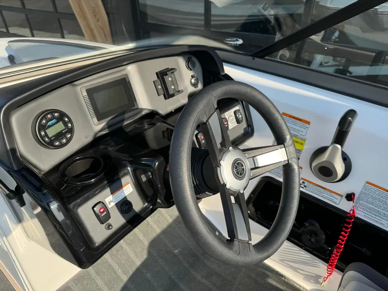 Slide: The Image of 2021 Yamaha AR190 boat dashboard with steering wheel and control panel. - 9