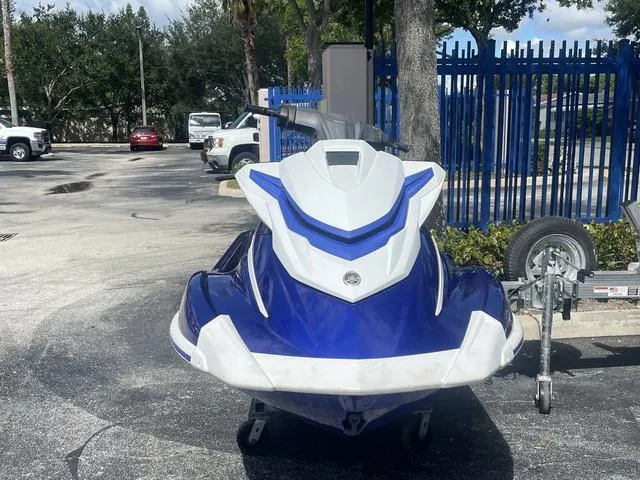Slide: The Image of 2018 Yamaha WaveRunner GP1800 in blue, parked on pavement near a trailer. - 4