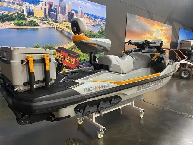 Slide: The Image of 2024 Sea-Doo Waverunner FISH PRO on display indoors with cityscape backdrop. - 6