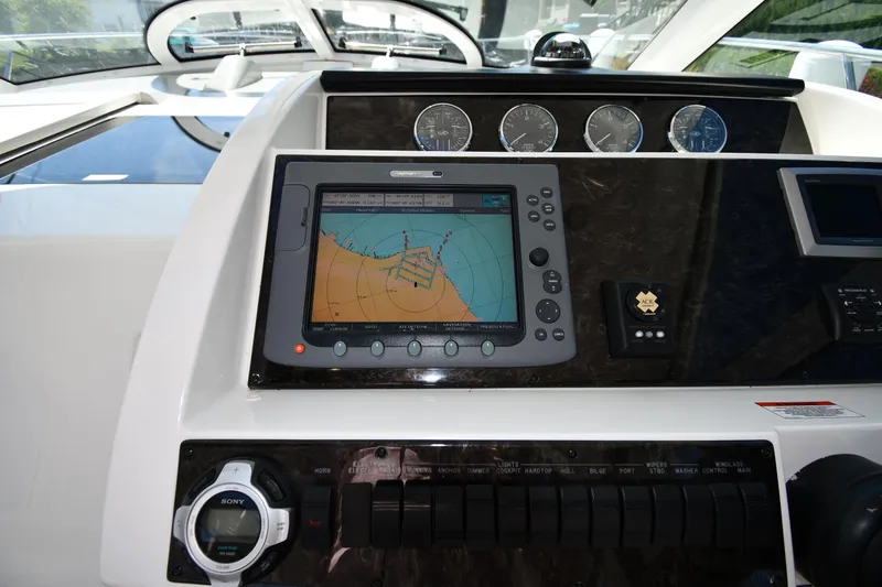 Slide: The Image of Dashboard of 2010 Sea Ray 450 Sundancer with navigation system and gauges. - 15