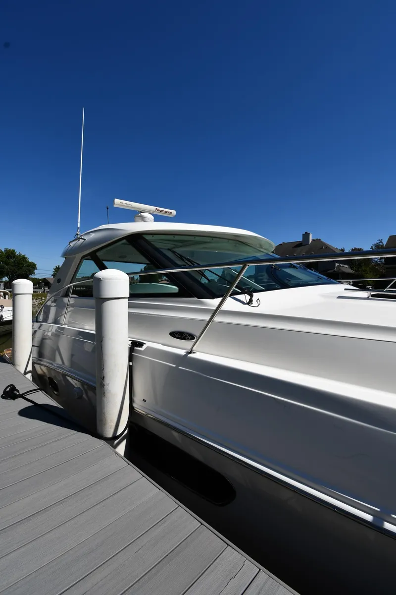 Slide: The Image of 2010 Sea Ray 450 Sundancer yacht docked under clear blue sky. - 2