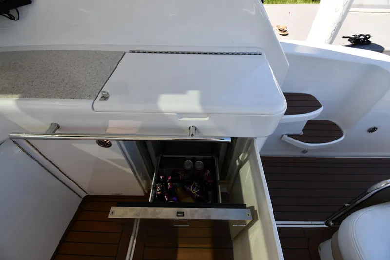 Slide: The Image of 2010 Sea Ray 450 Sundancer boat with open storage compartment on deck. - 29