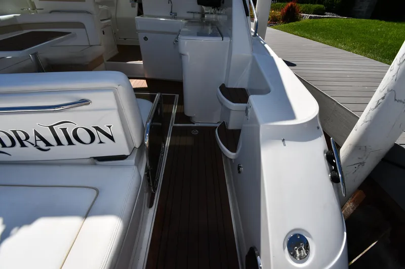 Slide: The Image of 2010 Sea Ray 450 Sundancer yacht interior with white seating and wooden flooring. - 30