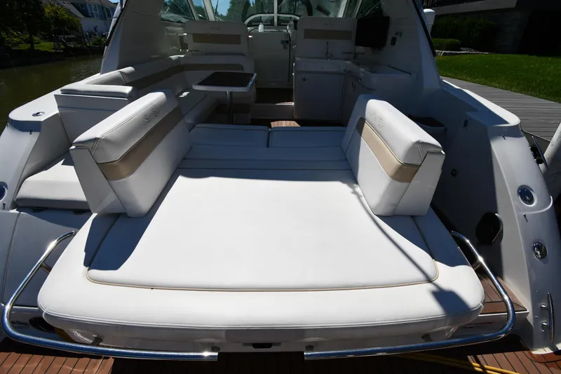 Slide: The Image of 2010 Sea Ray 450 Sundancer yacht with spacious white seating area. - 31