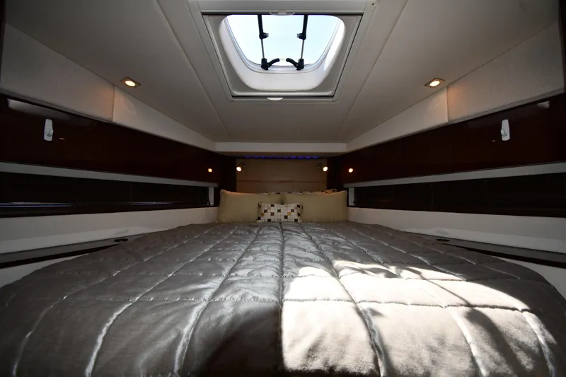 Slide: The Image of Luxurious cabin interior of 2010 Sea Ray 450 Sundancer yacht with skylight and plush bedding. - 34