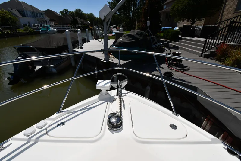 Slide: The Image of Bow view of 2010 Sea Ray 450 Sundancer docked at a marina. - 4