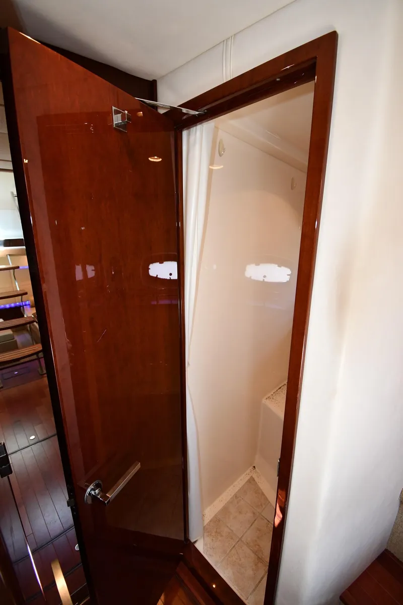 Slide: The Image of Interior view of 2010 Sea Ray 450 Sundancer yacht, featuring a wooden door and shower area. - 41