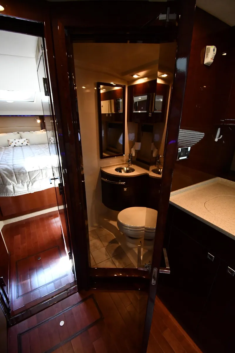 Slide: The Image of Luxurious interior of 2010 Sea Ray 450 Sundancer yacht, featuring bedroom and bathroom. - 43