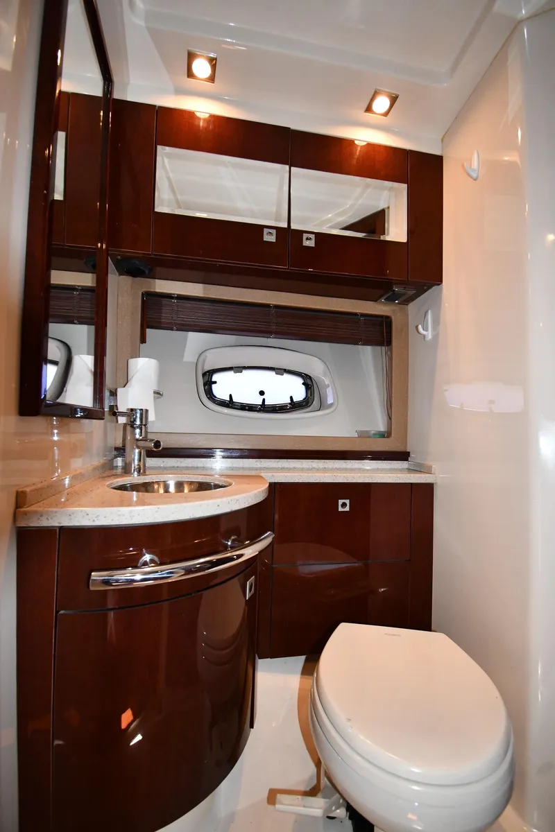Slide: The Image of Luxurious bathroom in 2010 Sea Ray 450 Sundancer yacht with modern fixtures and wood accents. - 45