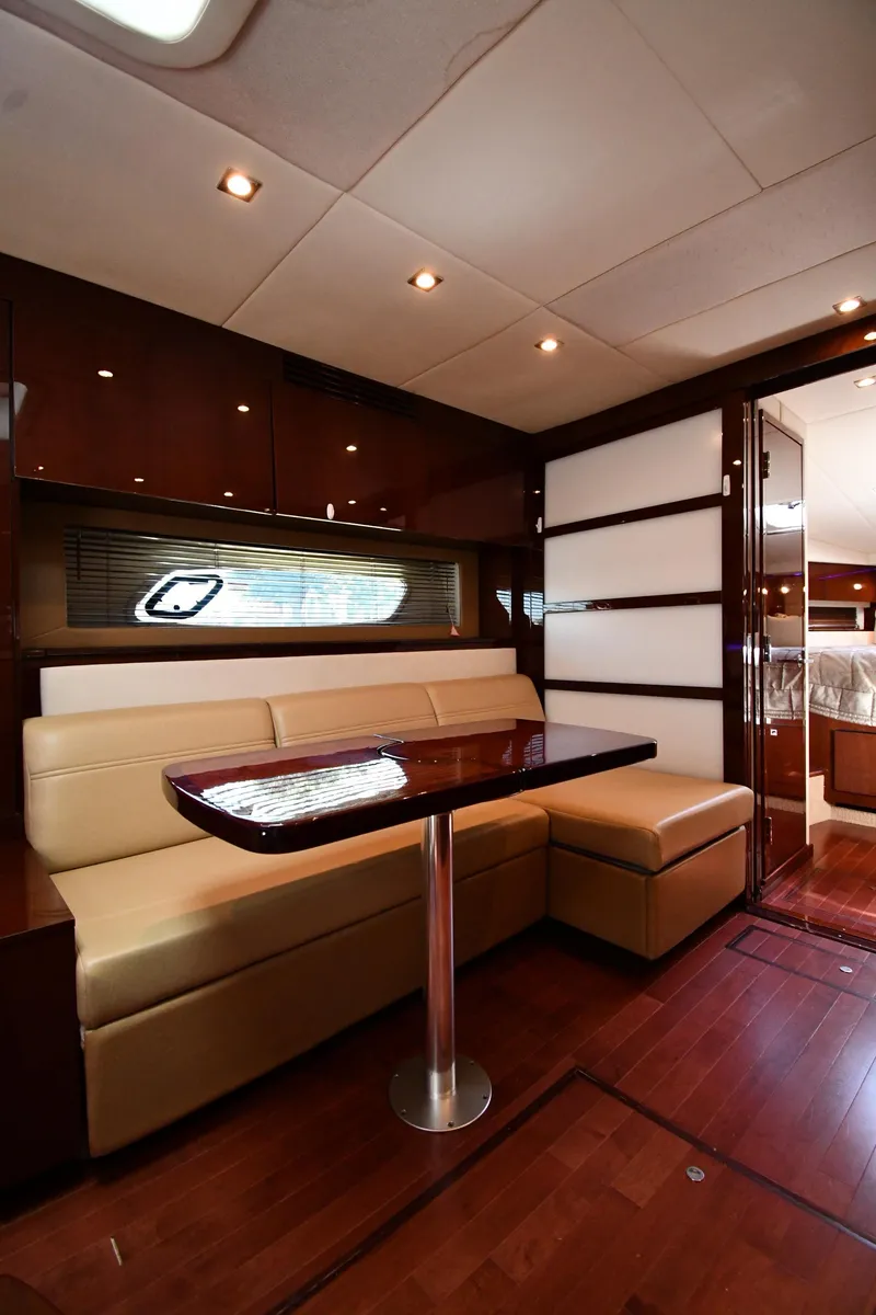 Slide: The Image of Luxurious interior of 2010 Sea Ray 450 Sundancer yacht with elegant seating and wooden finishes. - 49