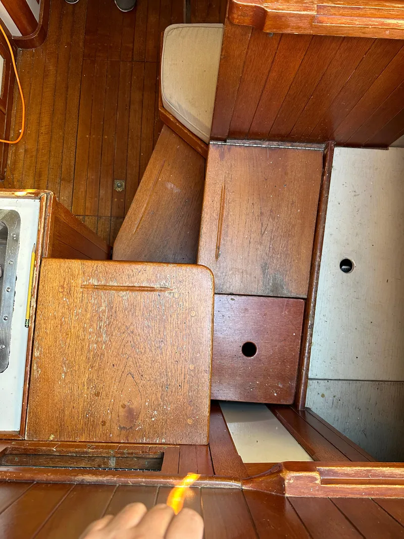 Slide: The Image of Interior view of a 1972 Mariner 31 Ketch sailboat with wooden cabinetry. - 12
