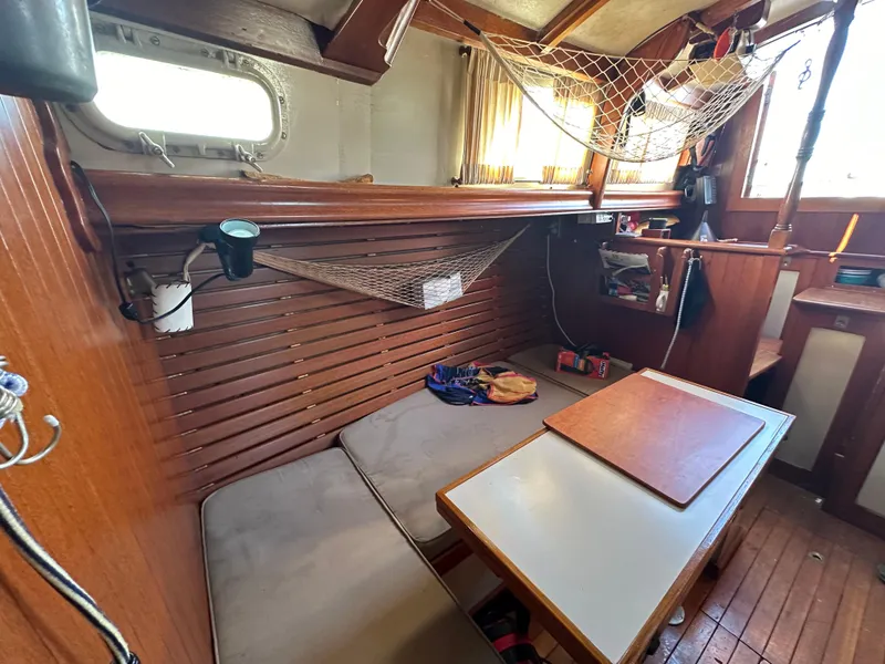 Slide: The Image of Interior of a 1972 Mariner 31 Ketch sailboat with cozy seating and wooden accents. - 15