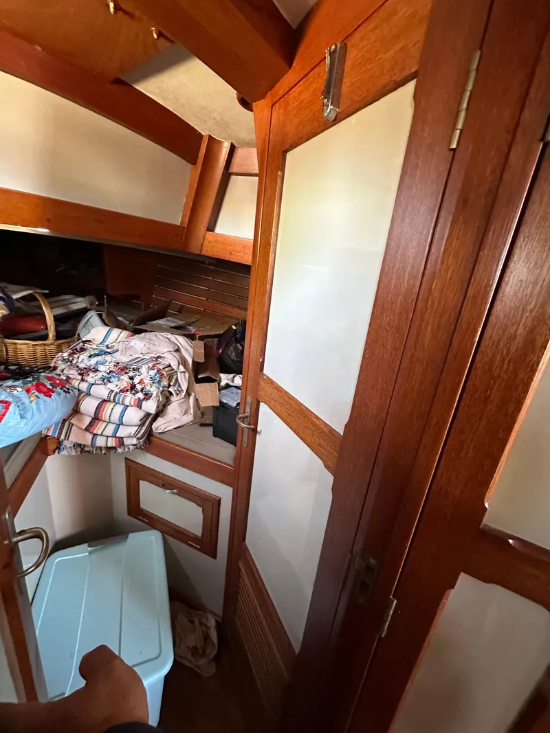 Slide: The Image of Interior of 1972 Mariner 31 Ketch with wooden paneling and storage area. - 16