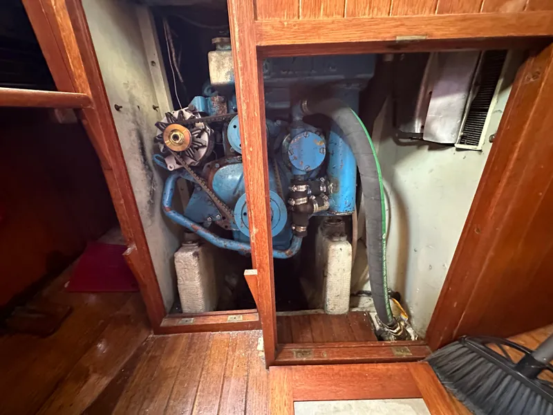 Slide: The Image of Engine compartment of a 1972 Mariner 31 Ketch sailboat, featuring a blue engine. - 18