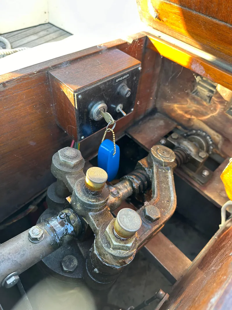 Slide: The Image of Engine compartment of a 1972 Mariner 31 Ketch sailboat, showing mechanical components and controls. - 26