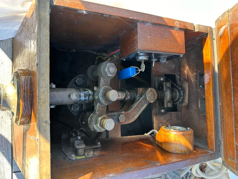 Slide: The Image of Interior view of a 1972 Mariner 31 Ketch, showcasing mechanical components and wooden housing. - 27