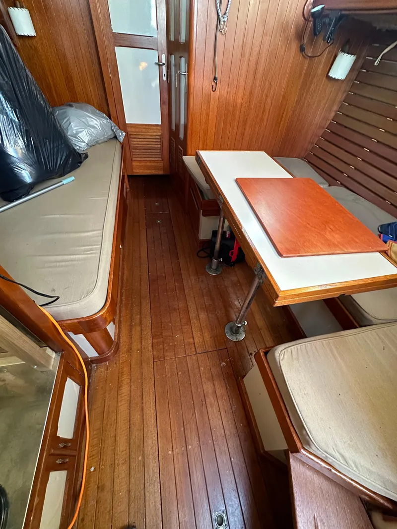 Slide: The Image of Interior of 1972 Mariner 31 Ketch with wooden paneling and seating area. - 28