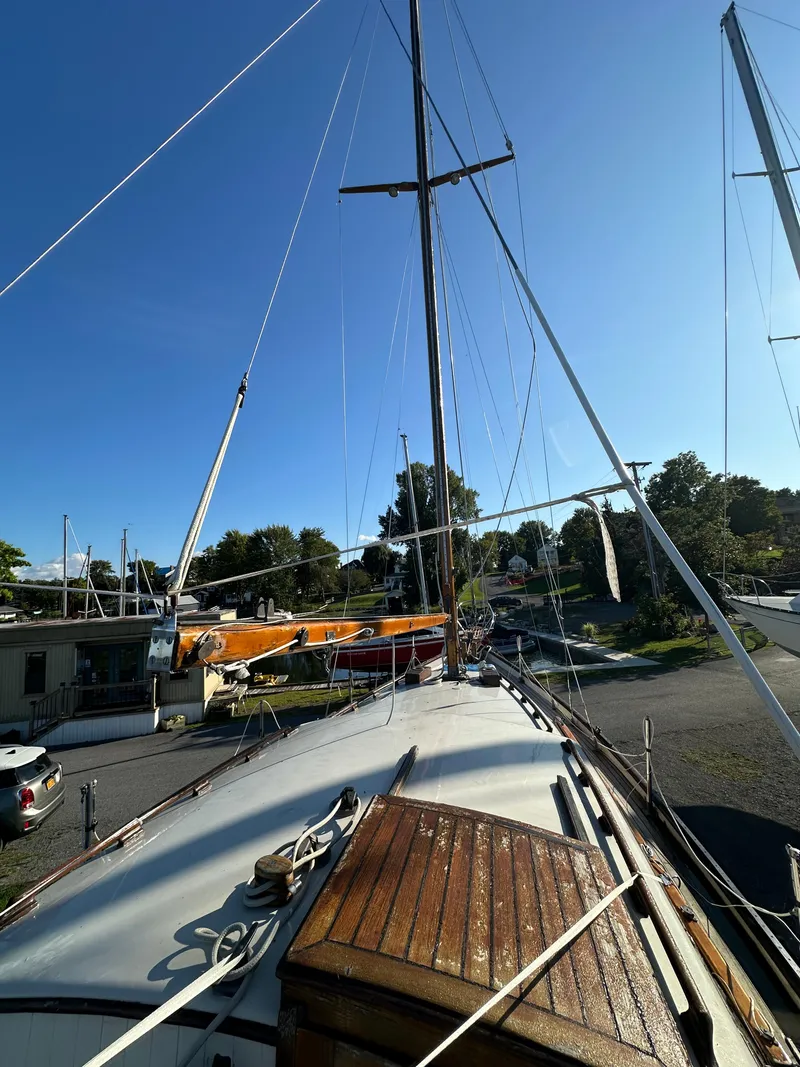 Slide: The Image of 1972 Mariner 31 Ketch sailboat docked under clear blue sky. - 7
