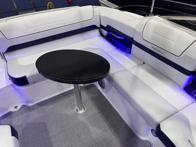 Slide: The Image of 2024 Formula 270 Bowrider interior with white seating and a round table. - 13
