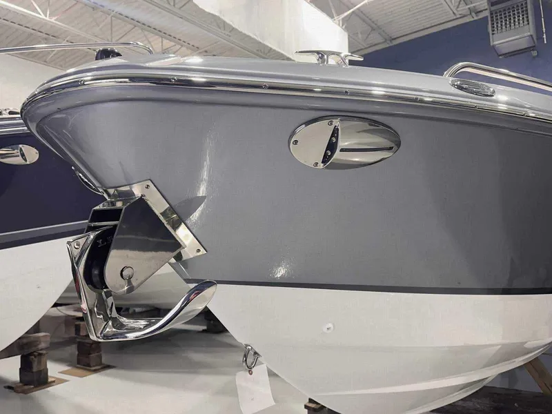 Slide: The Image of 2024 Formula 270 Bowrider boat, sleek gray and white hull, chrome accents. - 2