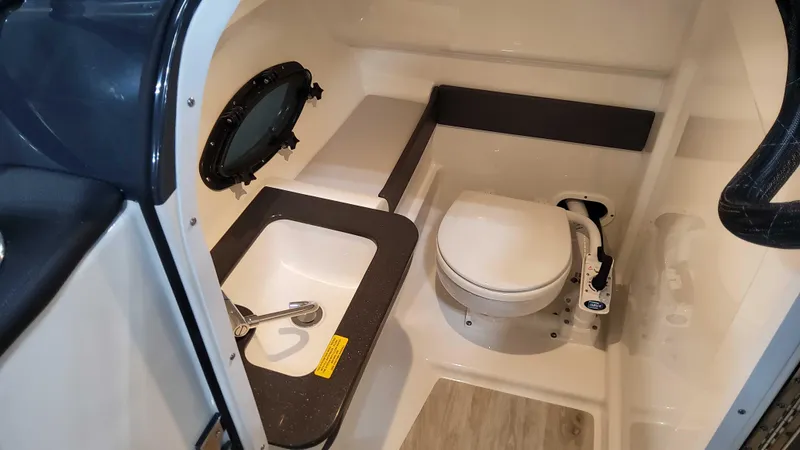 Slide: The Image of 2024 Formula 270 Bowrider interior with compact bathroom and sink. - 26