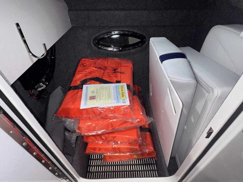Slide: The Image of Storage compartment with life jackets in a 2024 Formula 270 Bowrider boat. - 39