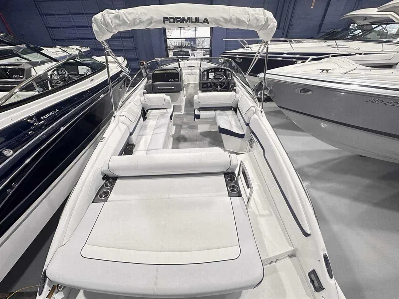 Slide: The Image of 2024 Formula 270 Bowrider boat with spacious seating and sleek design in showroom. - 8