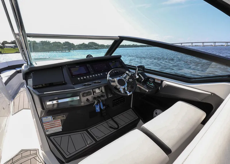 Slide: The Image of 2023 Monterey 385 Super Sport boat interior with modern dashboard and scenic water view. - 21