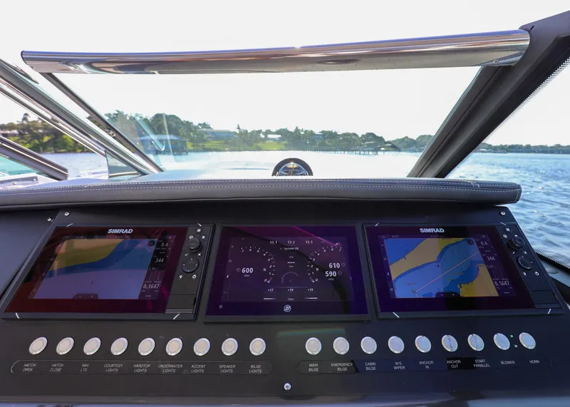 Slide: The Image of 2023 Monterey 385 Super Sport dashboard with navigation screens and controls on a sunny day. - 23