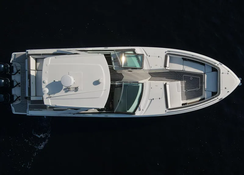Slide: The Image of Aerial view of 2023 Monterey 385 Super Sport boat on dark water. - 3