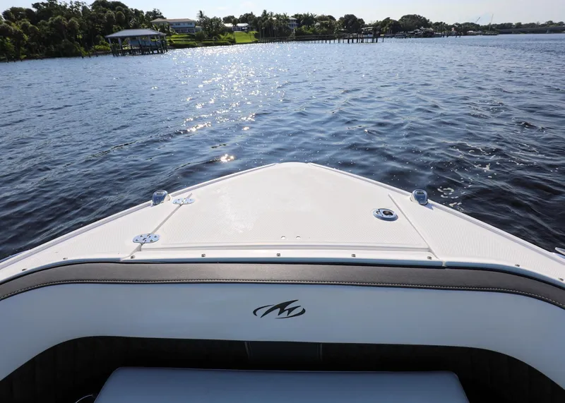 Slide: The Image of 2023 Monterey 385 Super Sport boat on calm water, sunny day. - 32