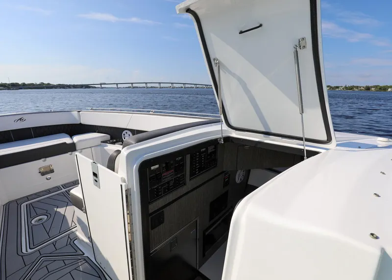 Slide: The Image of 2023 Monterey 385 Super Sport boat interior with open hatch, on calm water. - 36