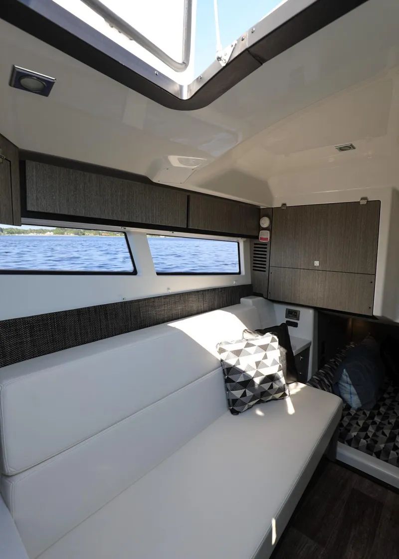 Slide: The Image of Interior of 2023 Monterey 385 Super Sport yacht with modern seating and lake view. - 38