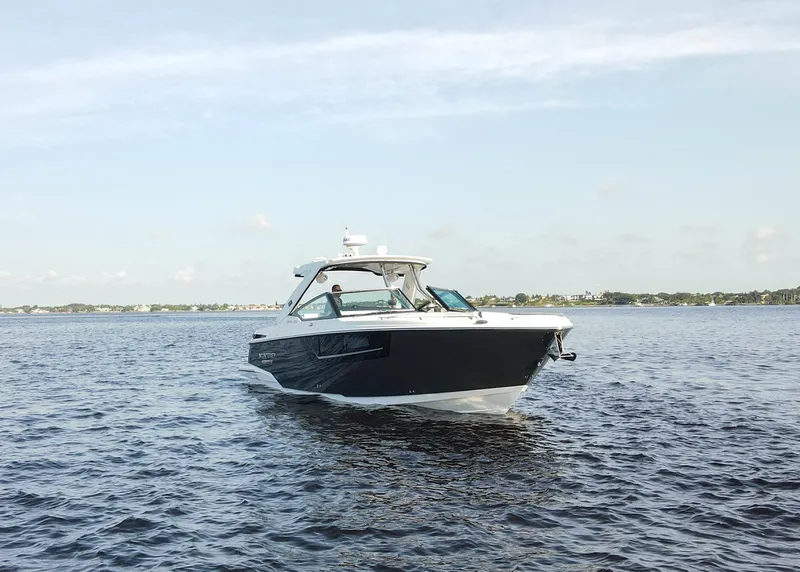 Slide: The Image of 2023 Monterey 385 Super Sport boat cruising on open water. - 5