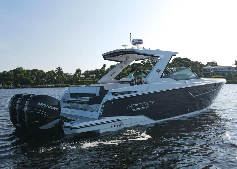 Slide: The Image of 2023 Monterey 385 Super Sport boat on water, featuring sleek design and powerful Mercury engines. - 6