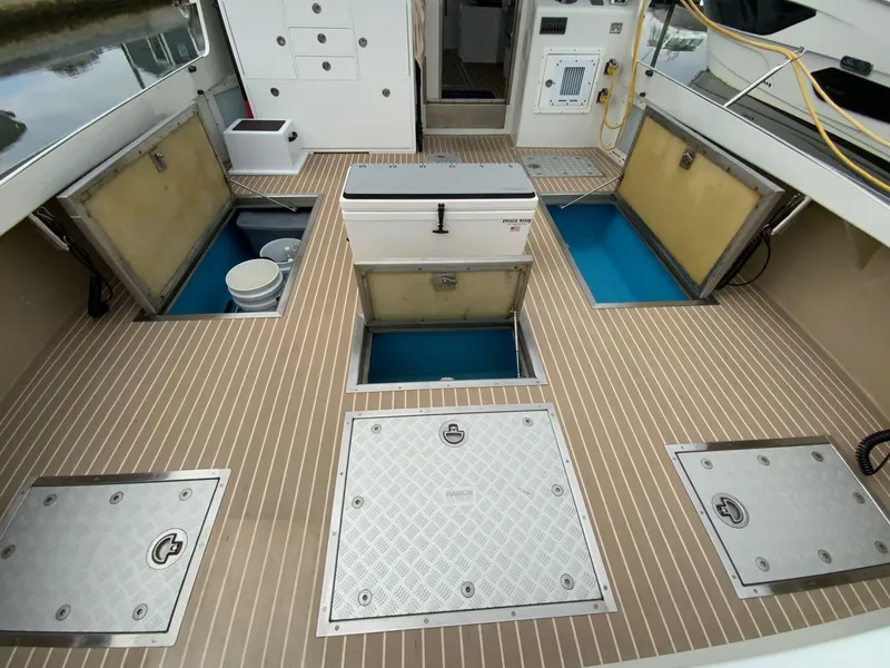 Slide: The Image of Cockpit storage with freezer on starboard, livewell and access to bilge areas - 10