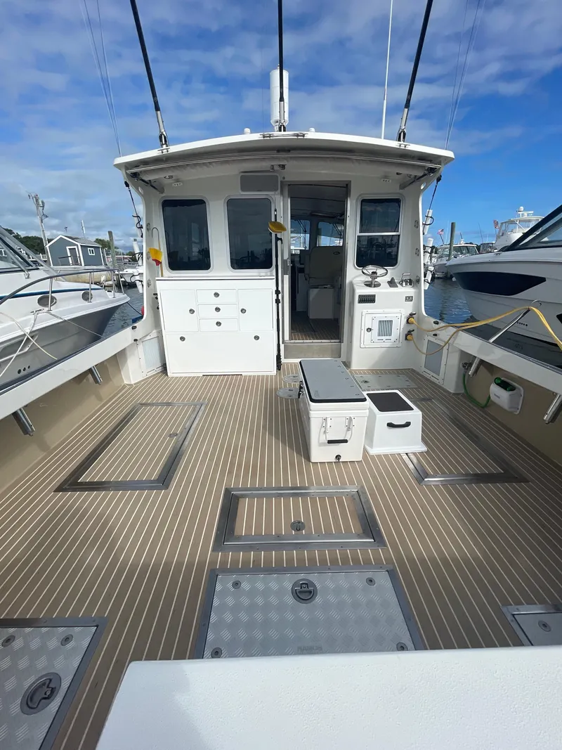 Slide: The Image of Open cockpit with dual fish boxes, Live well and easy access to stern systems - 8