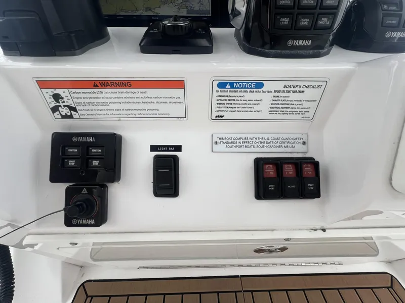 Slide: The Image of Control panel of a 2019 Southport 33 FE boat with Yamaha switches and warnings. - 12