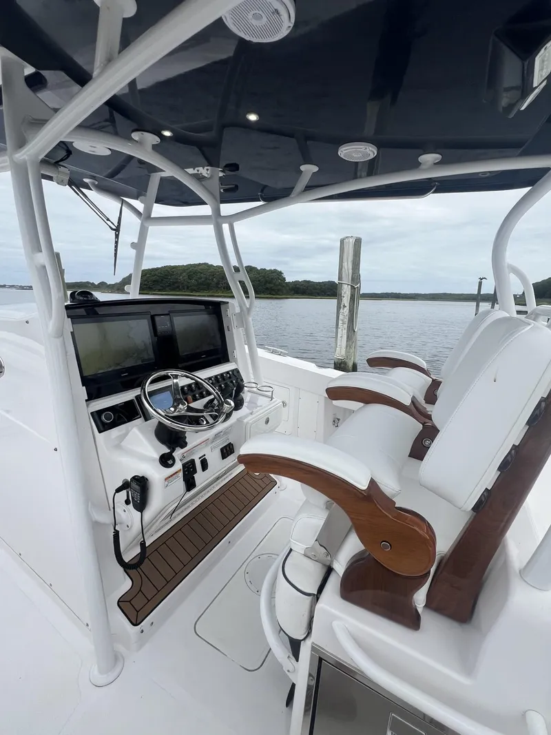 Slide: The Image of 2019 Southport 33 FE boat cockpit with dual seats and navigation controls. - 13