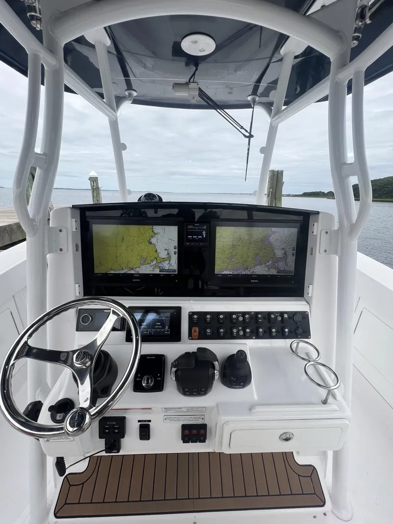 Slide: The Image of 2019 Southport 33 FE boat helm with dual navigation screens and controls. - 16