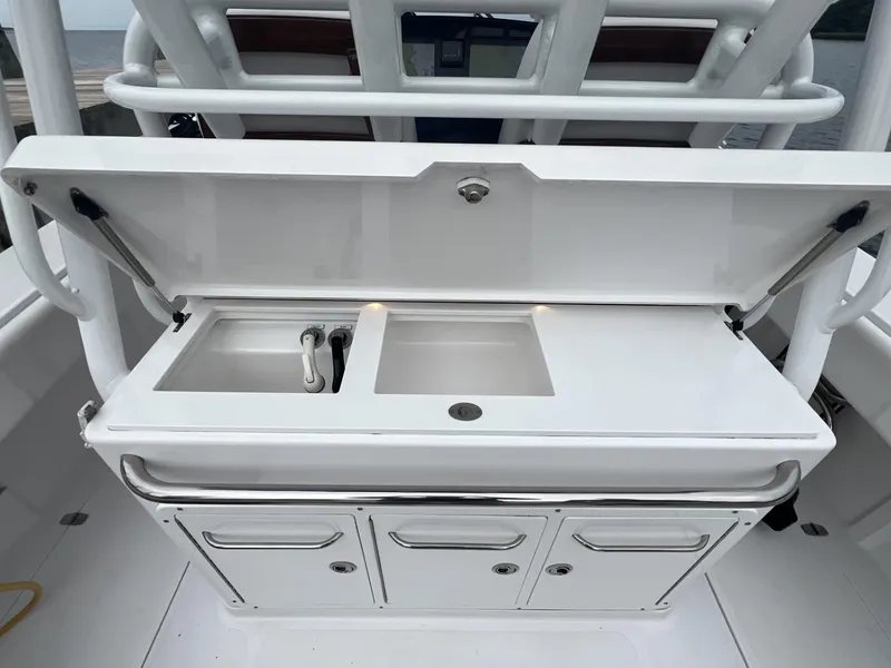 Slide: The Image of 2019 Southport 33 FE boat sink and storage area with open lid. - 6