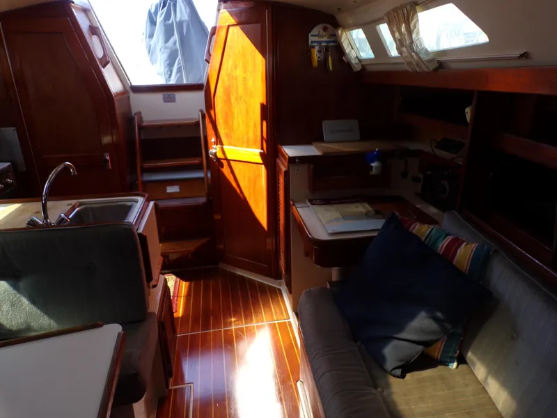 Slide: The Image of Interior of a 1991 Catalina 34 sailboat with wooden finishes and cozy seating area. - 11