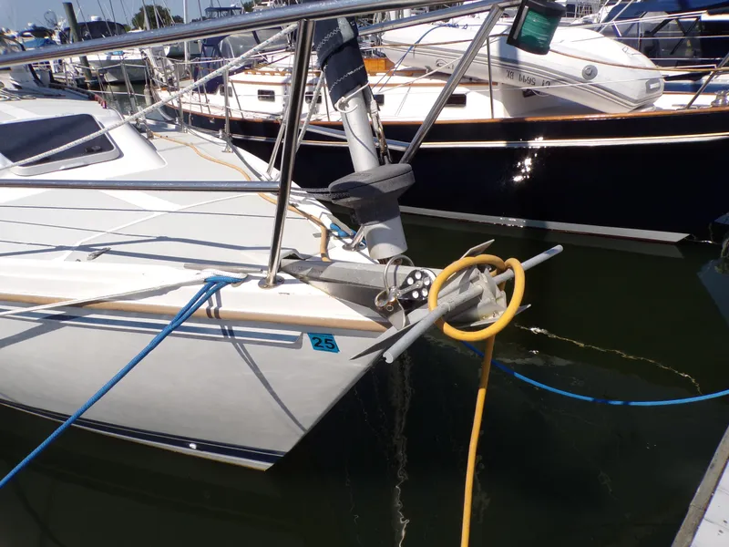 Slide: The Image of 1991 Catalina 34 sailboat docked with ropes and anchor visible. - 2