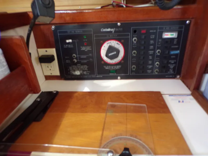 Slide: The Image of Control panel of a 1991 Catalina 34 sailboat with various switches and dials. - 20