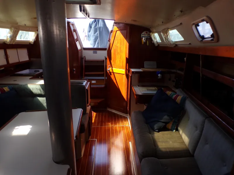Slide: The Image of Interior of a 1991 Catalina 34 sailboat with wooden flooring and cozy seating. - 22