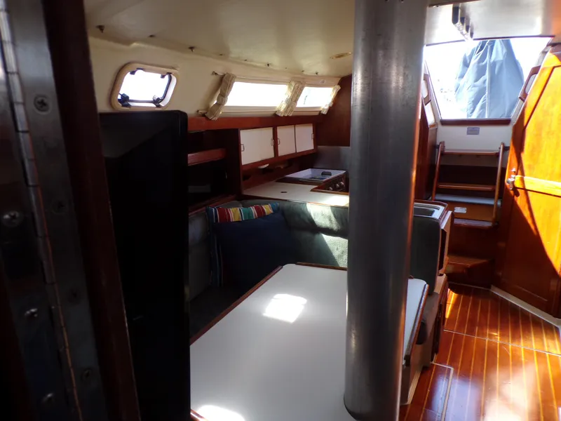 Slide: The Image of Interior of a 1991 Catalina 34 sailboat with seating and wooden finishes. - 23